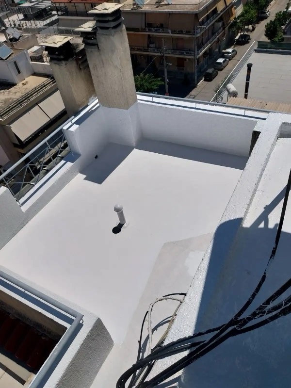 Liquid waterproofing membrane being applied to a roof surface